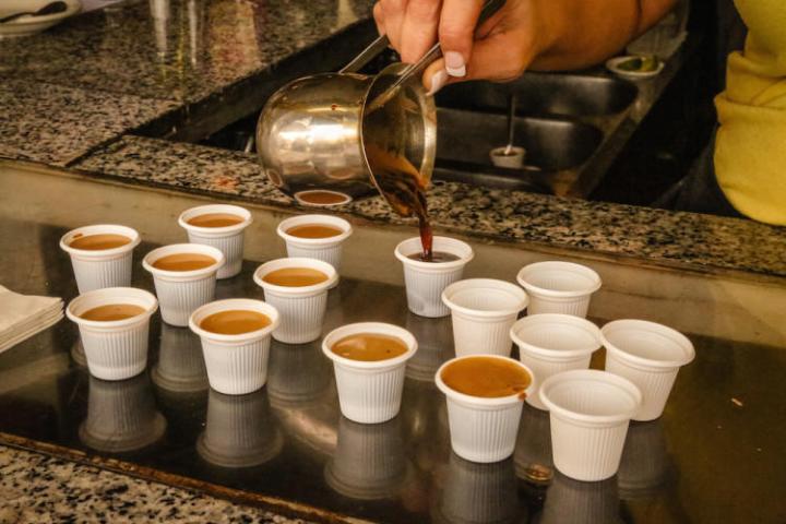a person holding a cup of coffee