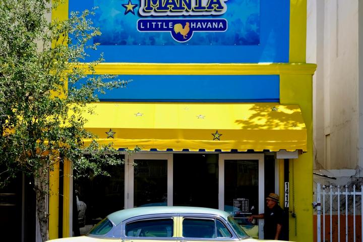 a blue car parked in front of a building
