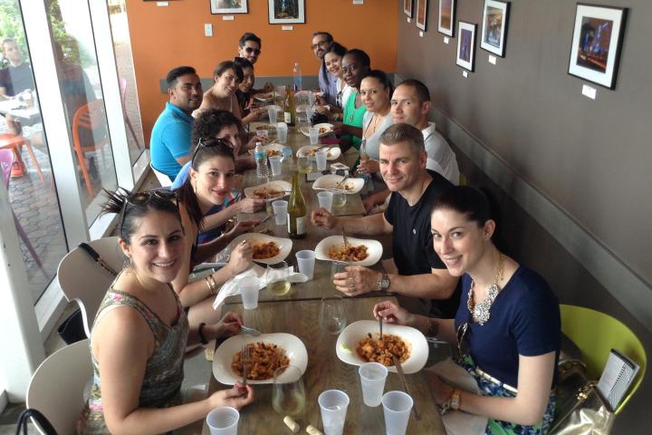 Christina Guzman et al. sitting at a table eating food