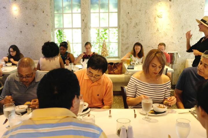 a group of people sitting at a table in a restaurant