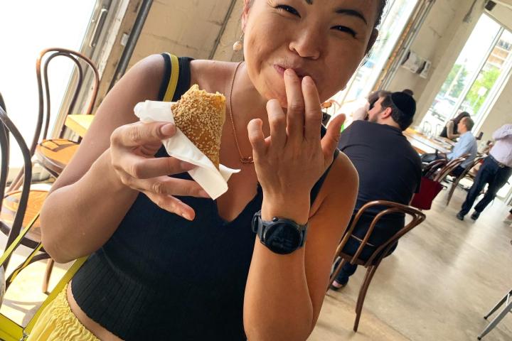 a woman eating a hot dog