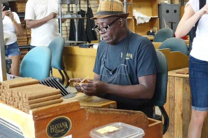 a group of people preparing food in a kitchen